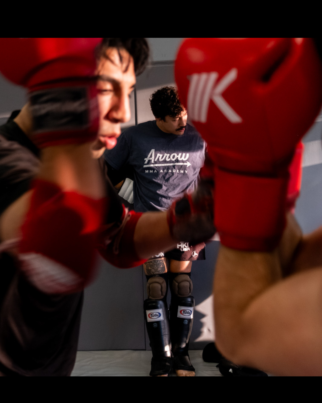 Arrow MMA Academy fighter training with red boxing gloves - Durham NC
